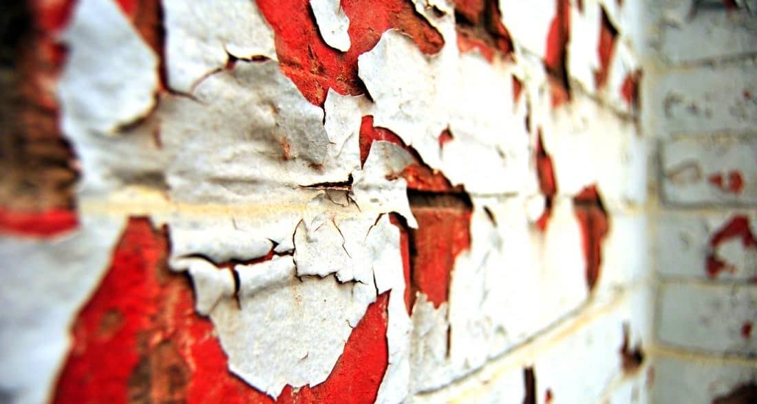 Peeling paint on bricks